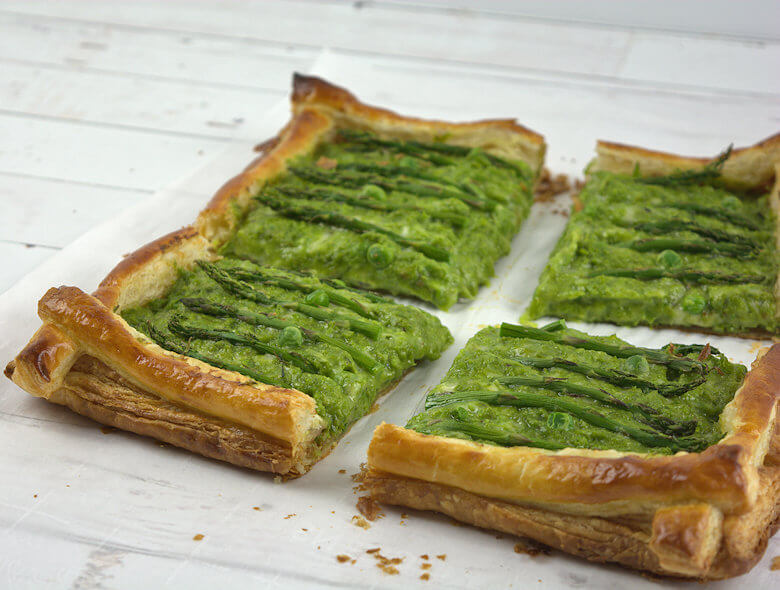Detailed cut aspargus tart with peas and gruyere