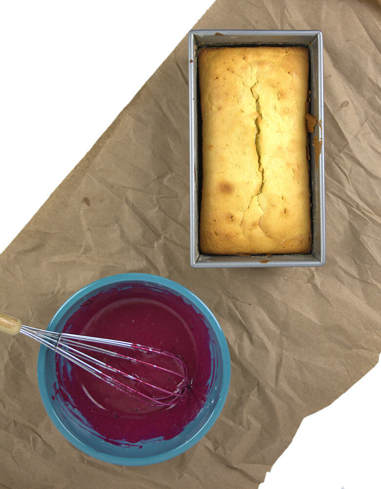 Picture of cake in loaf pan and blueberry glaze