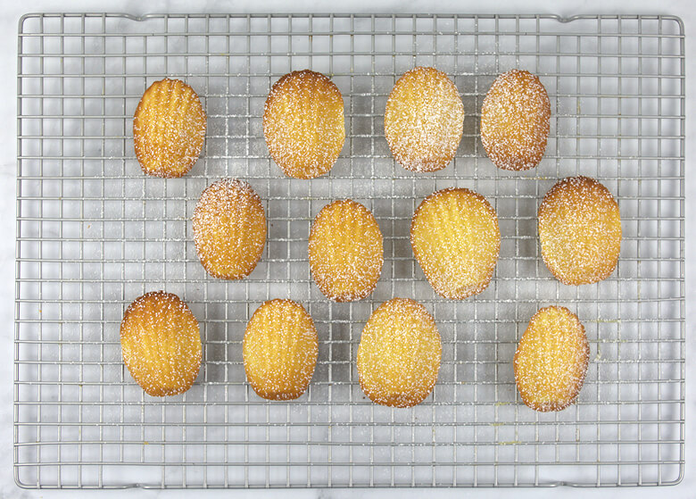 Dusted madeleines cooling on rack