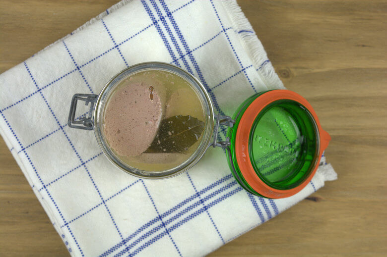 Picture of open jar of pickled liverwurst