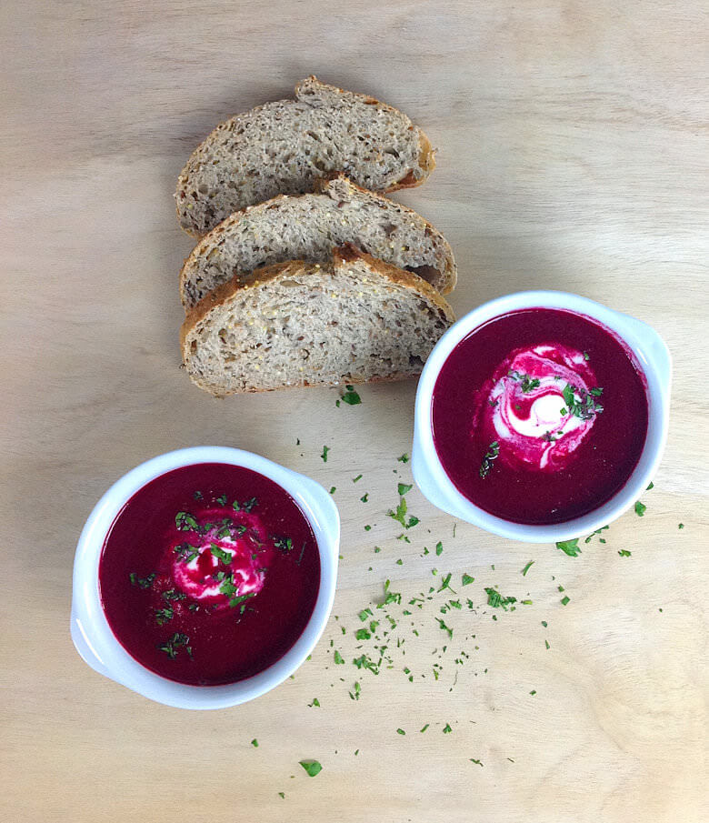 Picture of 2 bowls of Roasted Beet Soup with Apple and Creme Fraiche and slices of bread