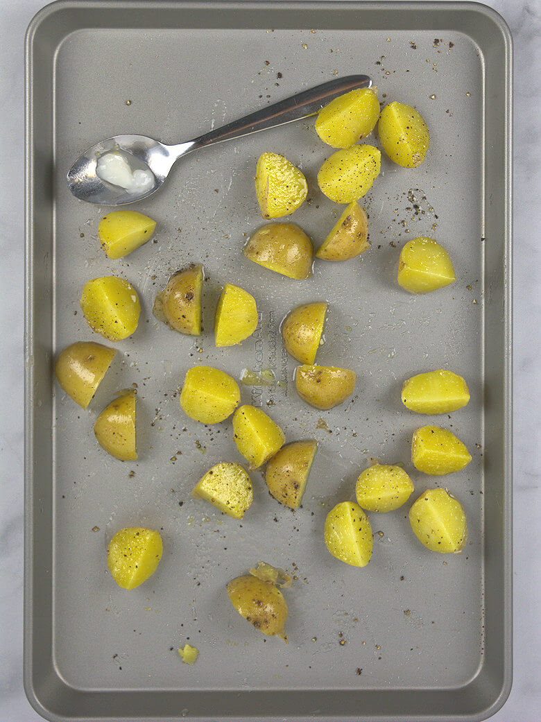 Picture of potatoes pieces on a baking sheet