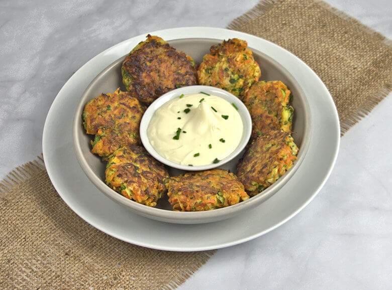 Picture of zucchini carrot fritters in bowl with creme fraich